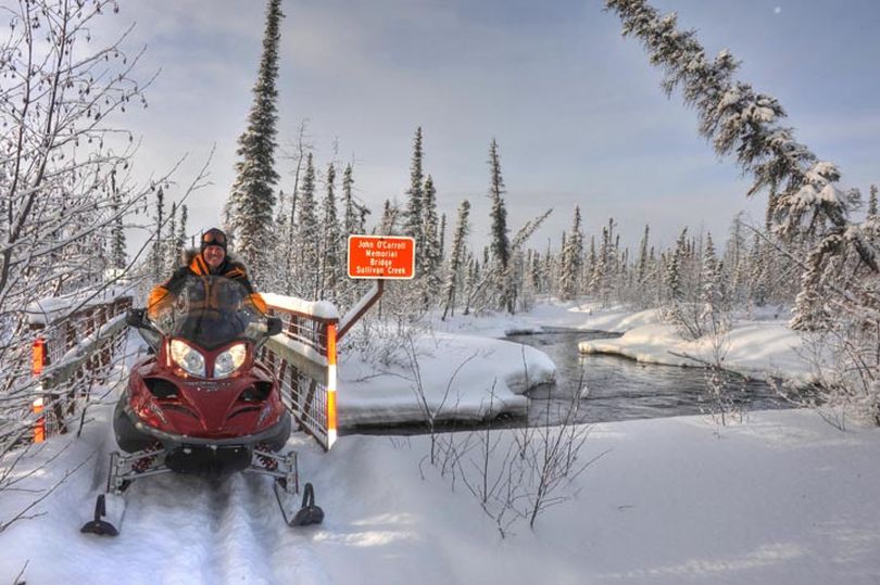 Josh Rindal coming over the bridge at Sullivan Creek south of Nicolai.  This warm-water stream never freezes and it would be an impossible crossing without this bridge along the Iditarod Trail. (Bob Jones)