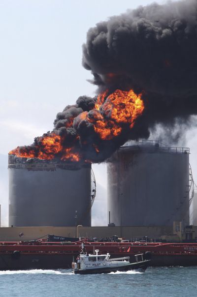Flames and smoke billow from an oil tank that exploded in the docks at Gibraltar on Tuesday. (Associated Press)