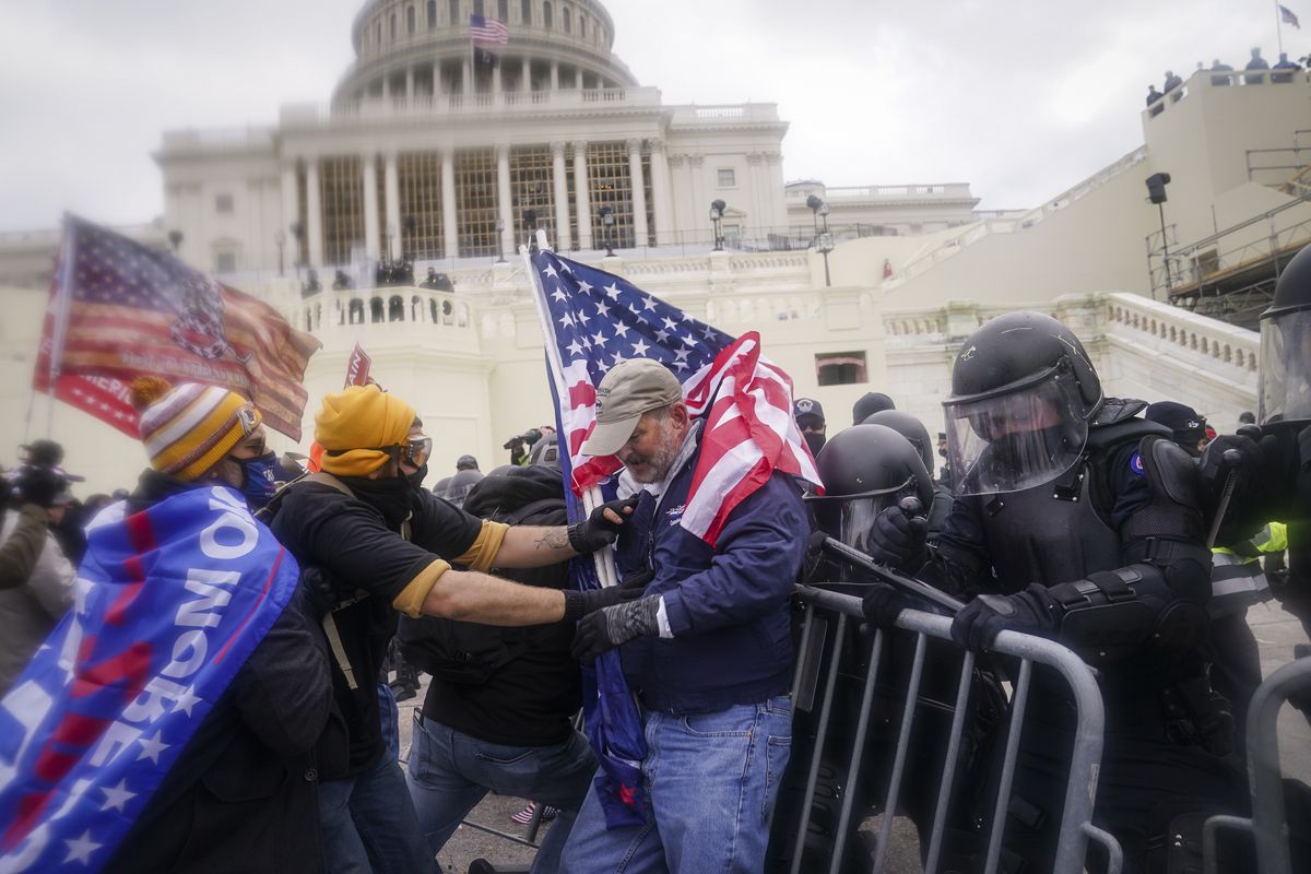 FILE – In this Jan. 6, 2021, file photo rioters try to break through a police barrier at the Capitol in Washington.  (John Minchillo)