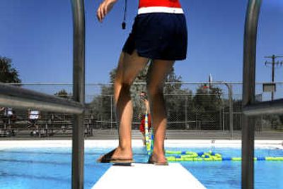 
Lifeguard Greg Bertsch, 21, pulls the ropes across the Valley Mission Pool while lifeguard Rachel Otte, 17, helps on Friday  in Spokane Valley. 
 (Jed Conklin / The Spokesman-Review)