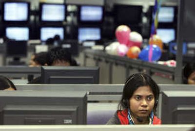 
An employee of business process outsourcing company Convergys Corp. speaks with a client in Gurgaon, a suburb of New Delhi, India. Associated Press
 (Associated Press / The Spokesman-Review)