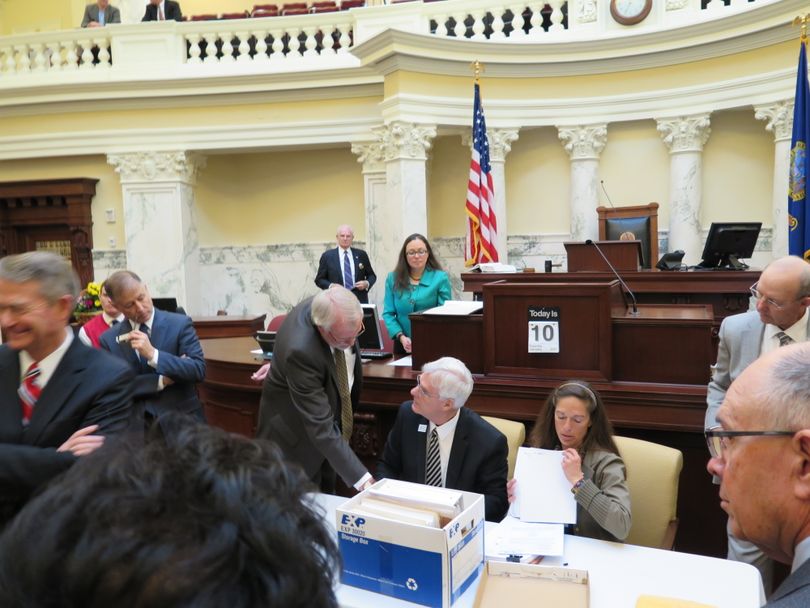 Senate President Pro-Tem Brent Hill and Minority Leader Michelle Stennett inventory the contents of a sealed box containing a challenge to the District 29 Senate elections results, with assistance from Chief Deputy Secretary of State Tim Hurst, left, as senators look on. The unusual ceremony took place Tuesday in the well of the Senate. (Betsy Z. Russell)