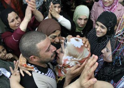 
Released Palestinian prisoner Mohannad Jaradat embraces his sister as he returns home Friday. Associated Press
 (Associated Press / The Spokesman-Review)