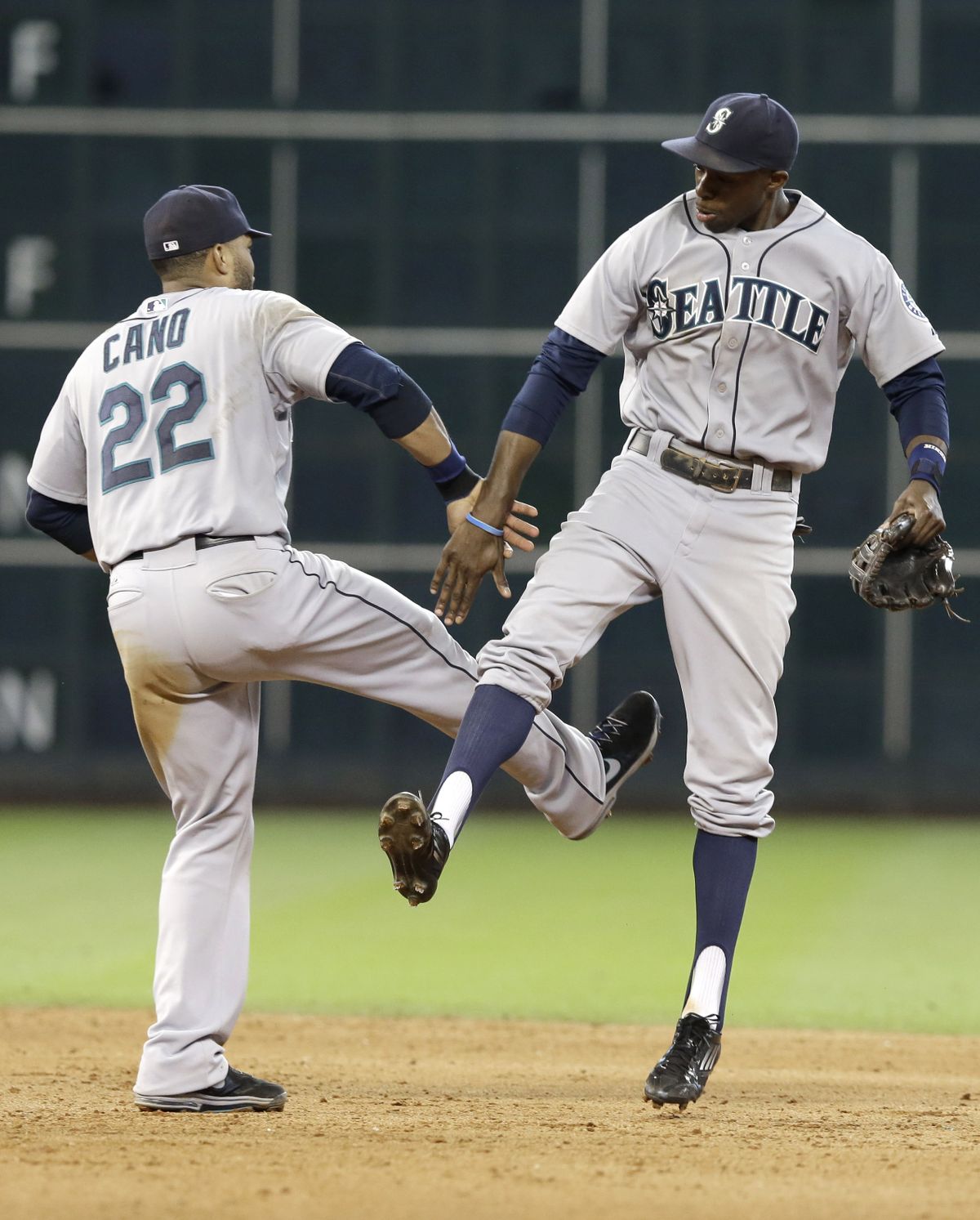 Mariners Robinson Cano, left, and James Jones show off some winning moves after Wednesday’s victory over Houston. (Associated Press)
