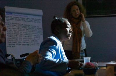 
Verdia Davis, front, listens as Jeanne Loy works with a team Tuesday trying to get Davis a job. Davis has been unemployed for two years, and the team is encouraging her to try new things such as buses and cell phones that can help her maintain her independence. 
 (Christopher Anderson / The Spokesman-Review)