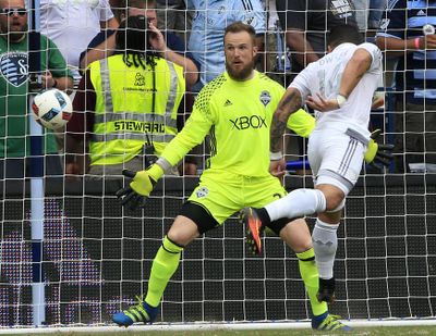 Sporting Kansas City forward Dom Dwyer, right, heads the ball into the net past Seattle Sounders goalkeeper Stefan Frei for a goal during the first half of an MLS soccer match in Kansas City, Kansas, on Sunday, July 24, 2016. (Associated Press)