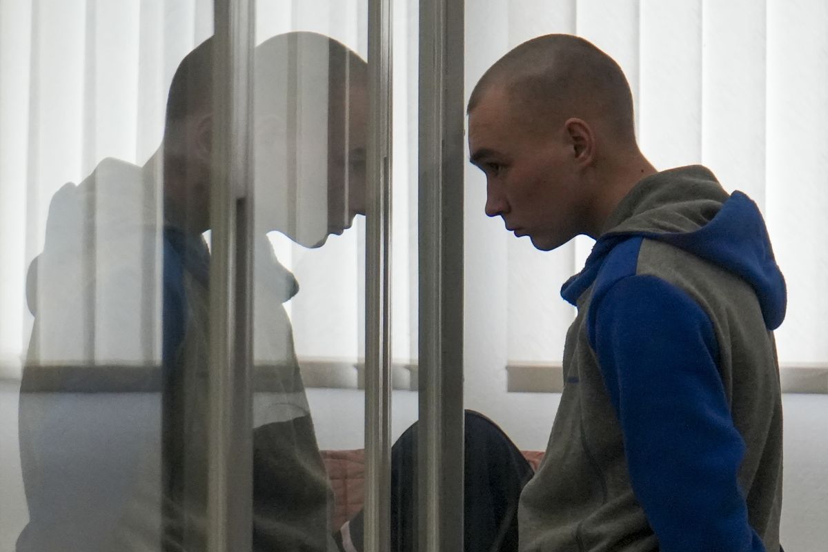 Russian Sgt. Vadim Shishimarin stands in court during a hearing in Kyiv, Ukraine, Thursday, May 19, 2022. The 21 year old Russian soldier facing the first war crimes trial since the start of the war in Ukraine testified Thursday that he shot a civilian on orders from two officers and pleaded for his victim