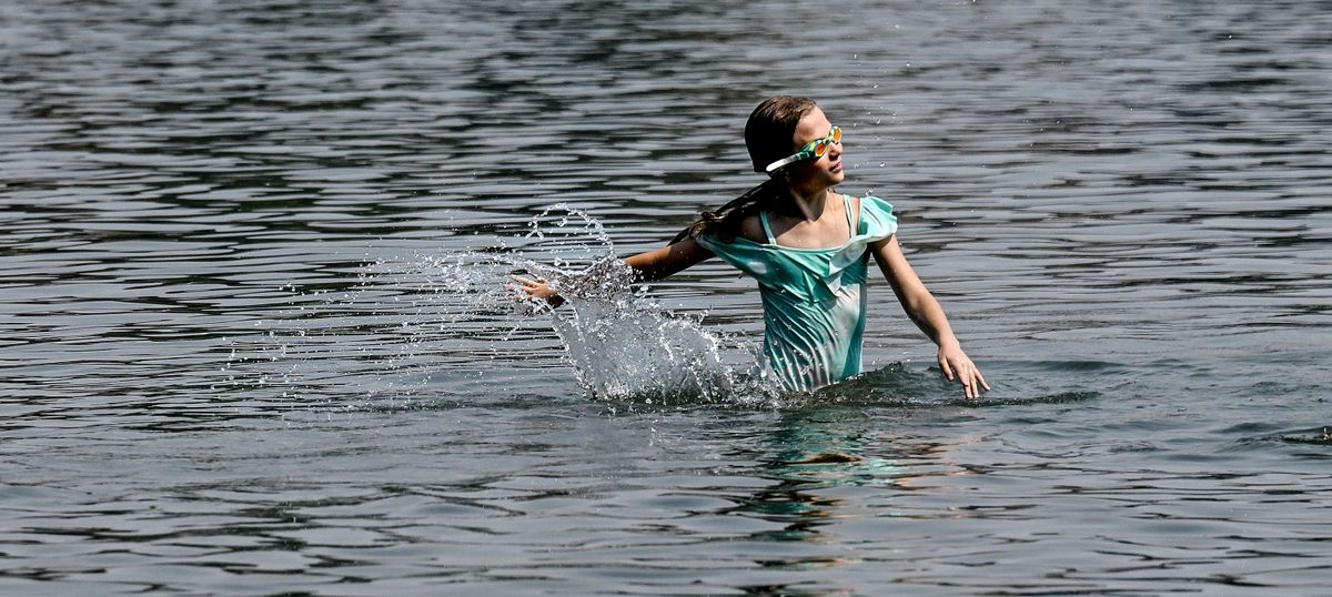 Ten-year-old Audrey Hockman of Seattle stays cool in the Spokane River at Q’emlin Park while visiting friends in Post Falls, Idaho, on Aug. 17, 2023.  (Kathy Plonka/The Spokesman-Review)