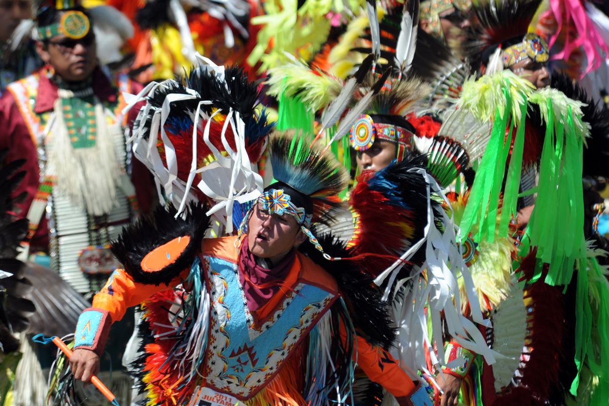 Dancers create a riot of color as the amplified sounds of drumming and singing enliven the dance circle Saturday at Julyamsh, the annual celebration of the Coeur d’Alene Tribe at Greyhound Park. (Jesse Tinsley)