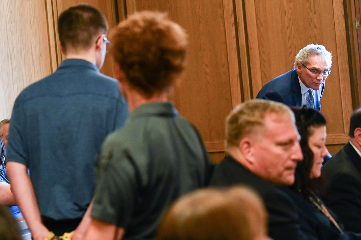 Shown here on Friday, defense Attorney Bevan J. Maxey, right, rises to greet his client Caleb Sharpe, 17, at the Spokane County Courthouse. Superior Court Judge Michael Price said Monday that he will announce Tuesday whether to keep Sharpe’s case in juvenile court or whether the accused Freeman High School shooter will be tried as an adult for first-degree murer and several other charges. (Tyler Tjomsland / The Spokesman-Review)