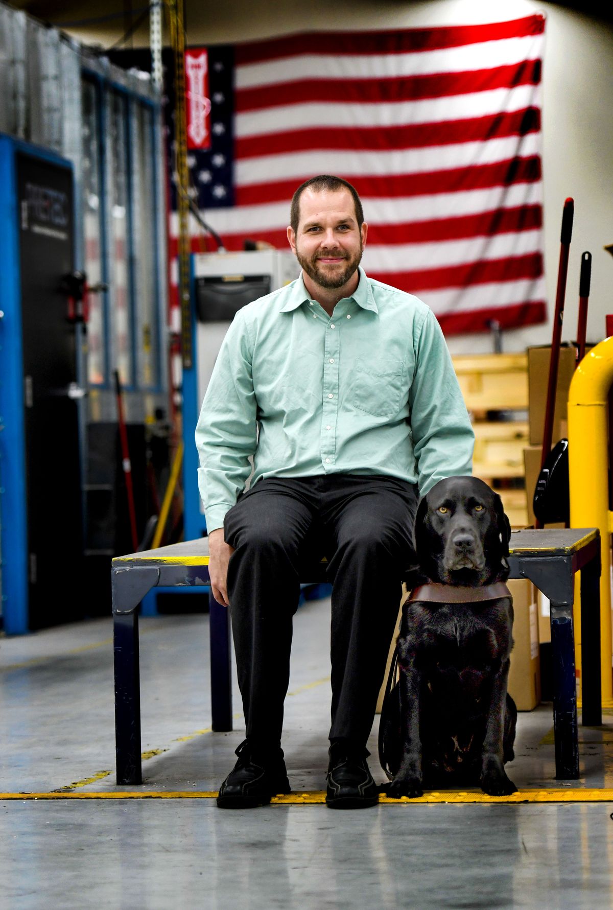 Greg Szabo sits on Aug. 4, 2022, with his guide dog, Keating, at Lighthouse for the Blind in Spokane where he is the director of public relations.  (Kathy Plonka/The Spokesman-Review)