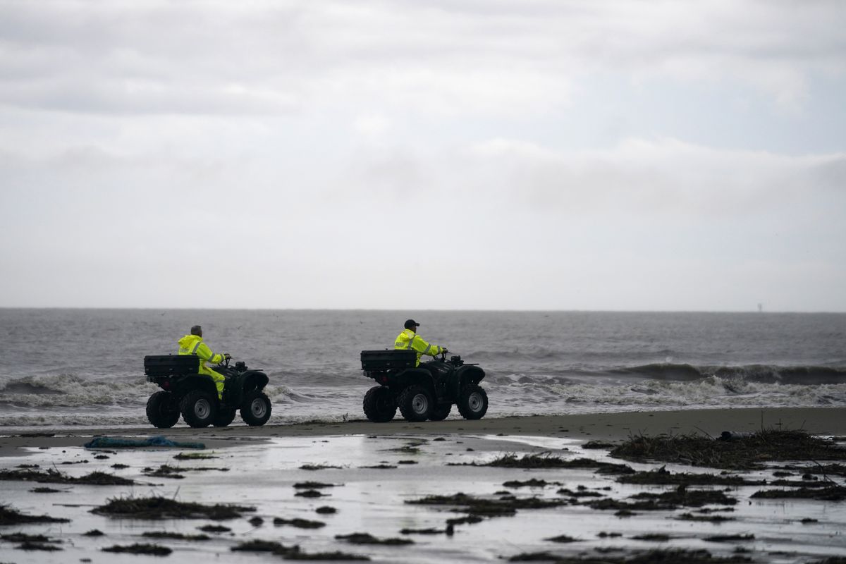 Lafourche Parish deputies patrol along the shoreline of the Gulf of Mexico, not far from where a lift boat capsized during a storm on Tuesday, killing one with 12 others still missing, on Elmer’s Island, La., Thursday, April 15, 2021.  (Gerald Herbert)