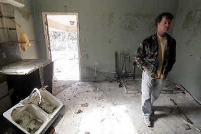 
Michael Shelley walks past a kitchen sink Wednesday in his Milne Street home in the Lakeview section of New Orleans. Shelley hopes to rebuild the house, which was in over 10 feet of water after the area flooded when a neighboring levee failed. 
 (Associated Press / The Spokesman-Review)