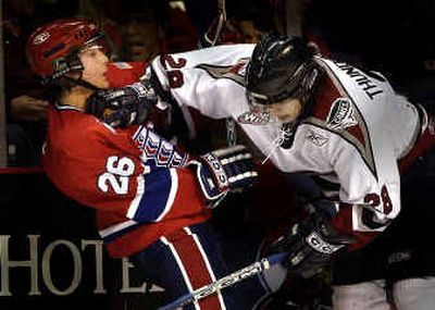
Lenny Thunderchild, right, of the Hurricanes hits Seth Compton  of the Spokane Chiefs with a little thunder during the first period of Tuesday's Western Hockey League game at the Arena. 
 (Brian Plonka / The Spokesman-Review)