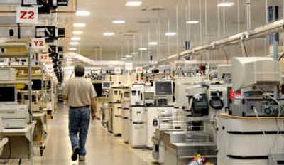 An IBM employee walks through the Retail Test Super Lab, where Anyplace Kiosks are tested, in Research Triangle Park, N.C. Associated Press photos
(Associated Press photos / The Spokesman-Review)