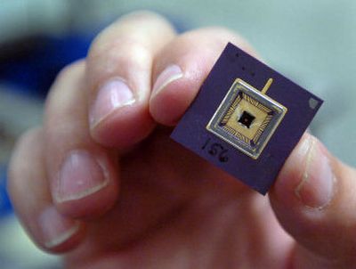 
Senior researcher William Smith holds a tiny silicon chip that was  developed at the University of Idaho research park  in Post Falls. 
 (Jesse Tinsley / The Spokesman-Review)