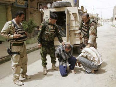 
Iraqi  soldiers detain two suspected terrorists  Thursday as U.S. and Iraqi troops continue their operations to clear Sunni extremists from the eastern part of Baqouba, 35 miles north of Baghdad. Associated Press
 (Associated Press / The Spokesman-Review)