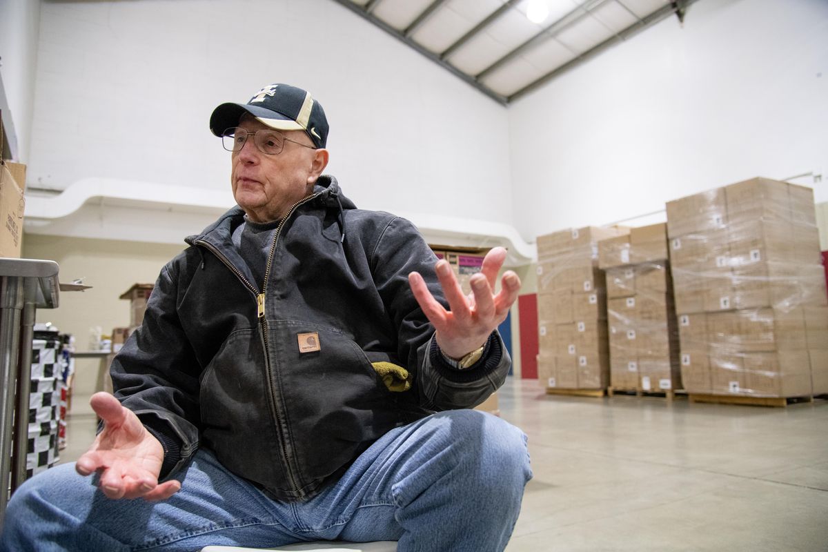 Longtime volunteer Ron Waybright takes a break to talk about his diagnosis of non-Hodgkins lymphoma this year and his decision to come back and volunteer after completing chemotherapy Wednesday to help set up the annual Christmas Bureau at the Spokane Fair and Expo Center. (SR)