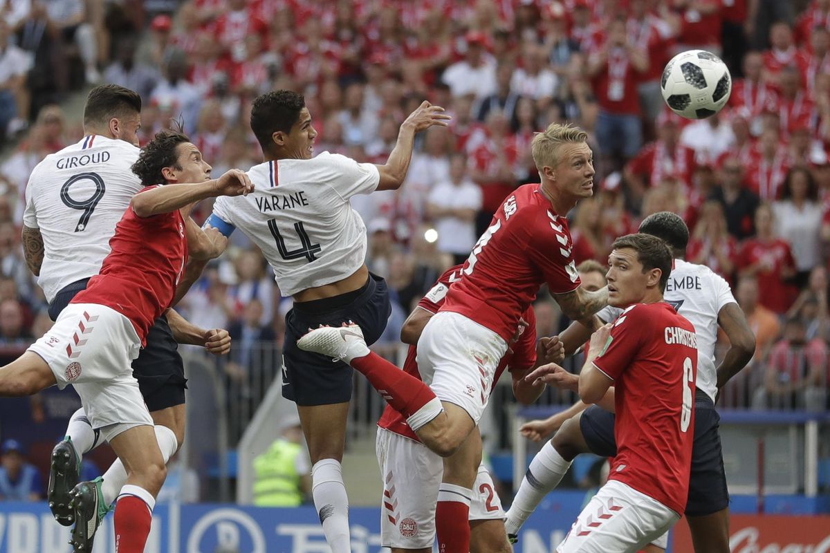 Denmark’s Simon Kjaer, top centre right, heads the ball under pressure from France’s Raphael Varane top center left, during the Group C match between Denmark and France at the 2018 soccer World Cup at the Luzhniki Stadium in Moscow, Russia, Tuesday, June 26, 2018. (Matthias Schrader / Associated Press)