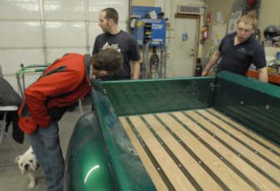 Mike Shea inspects the work of Corey Gilbert, left, of CG Customs,  and Matt Ayers, right.
 (The Spokesman-Review)