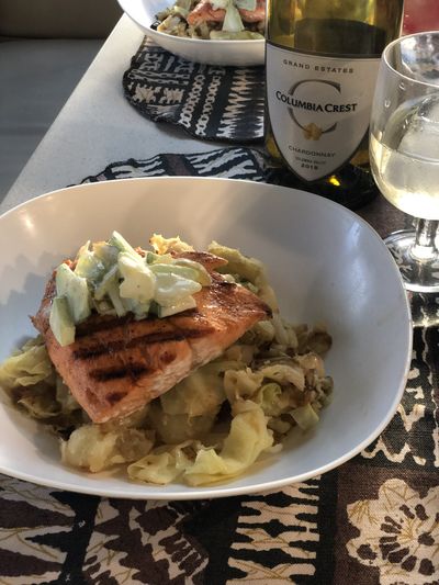 Fried potatoes and cabbage make a fine foundation for a cast iron skillet-seared wild salmon fillet. (Leslie Kelly)