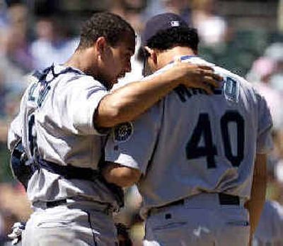 
Mariners catcher Miguel Olivo talks to reliever Julio Mateo (40) after walking Oakland's Damian Miller. 
 (Associated Press / The Spokesman-Review)