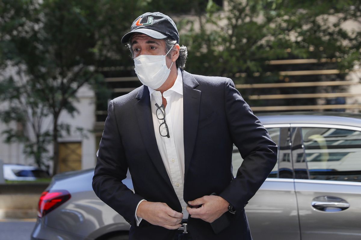 FILE- In this May 21, 2020 file photo, Michael Cohen arrives at his Manhattan apartment in New York after being furloughed from prison because of concerns over the coronavirus. Cohen was furloughed from prison along with other prisoners as authorities tried to slow the spread of the coronavirus in federal prisons. He was returned to prison on July 9, 2020 because he refused to sign an agreement over terms of his home confinement, not because he planned to publish a book critical of Trump, prosecutors said Wednesday, July 22, 2020.  (John Minchillo)