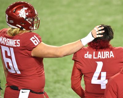 Washington State Cougars offensive lineman Hunter Mayginnes (61) pats quarterback Jayden de Laura (4) on the head after WSU fell to Oregon during the second half of a college football game on Saturday, November 14, 2020, at Martin Stadium in Pullman, Wash. (Tyler Tjomsland / The Spokesman-Review)