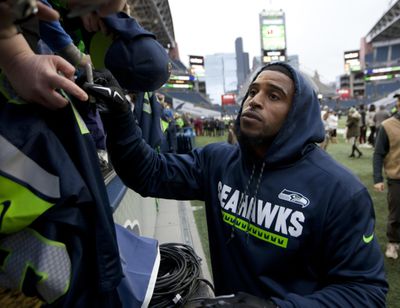 Seattle Seahawks middle linebacker Bobby Wagner gives autographs to fans before an NFL football game against the Los Angeles Rams, Sunday, Dec. 17, 2017, in Seattle. (John Froschauer / Associated Press)