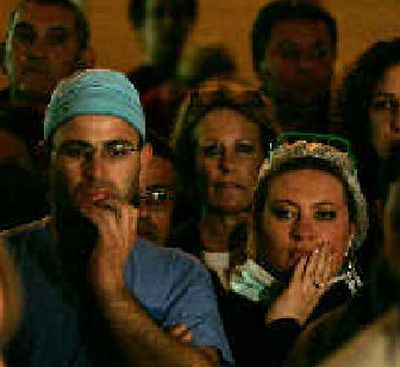 
Israelis listen to a briefing Saturday at Hadassah-Ein Kerem Hospital in Jerusalem on the condition of Prime Minister Ariel Sharon. 
 (Associated Press / The Spokesman-Review)