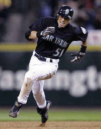 
Seattle's Ichiro Suzuki rounds second base on his way to a sixth-inning triple against Boston. 
 (Associated Press / The Spokesman-Review)
