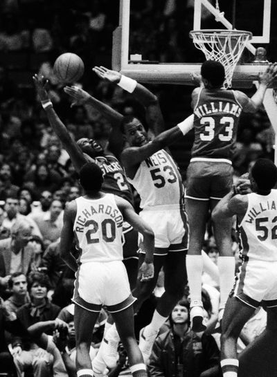 The 76ers' Moses Malone (2) tries to grab a rebound from the Nets' Darryl Dawkins (53) as Micheal Ray Richardson (20) watches. (Associated Press)