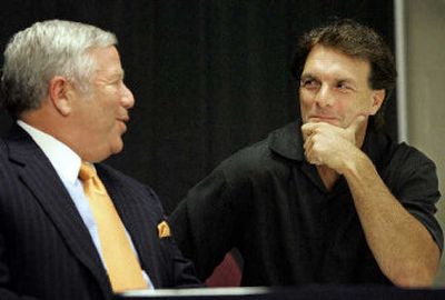 
Quarterback Doug Flutie, right, sits with Patriots owner Robert Craft after announcing his retirement. 
 (Associated Press / The Spokesman-Review)