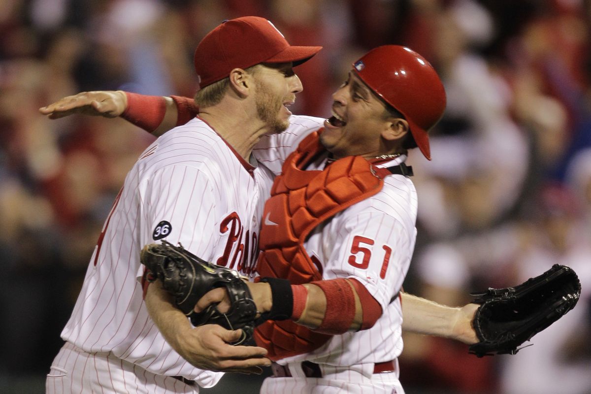 Philadelphia catcher Carlos Ruiz, right, greets Roy Halladay after the Phillies’ ace completed the second no-hitter in postseason history.  (Associated Press)