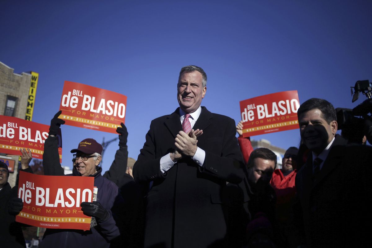 FILE - Democratic New York City mayoral candidate Bill de Blasio campaigns at a subway stop in New York, Monday, Nov. 4, 2013. De Blasio swept into the New York City mayor