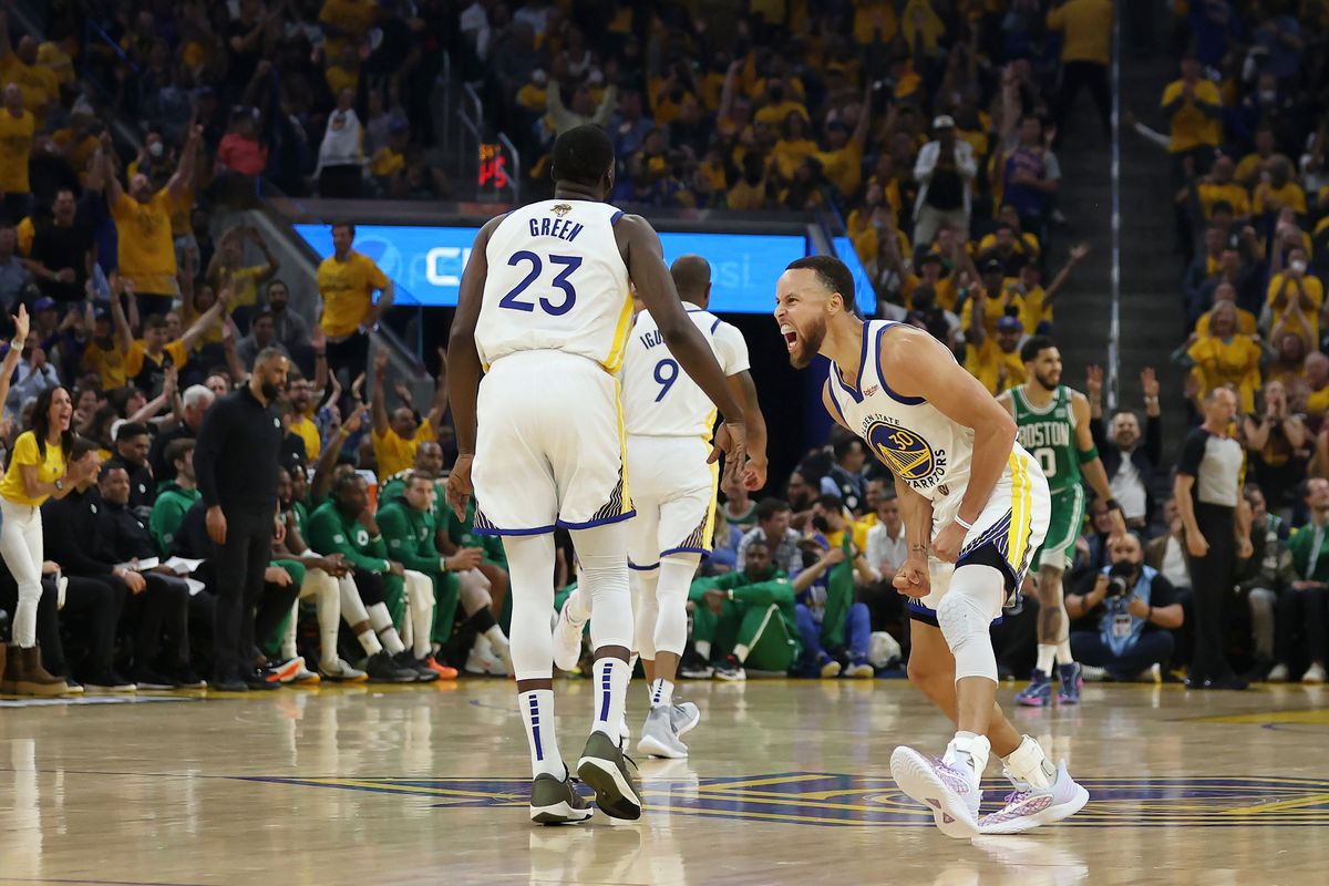 Golden State Warriors guard Stephen Curry, right, celebrates with forward Draymond Green (23) during the first half of Game 1 of basketball