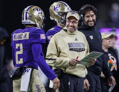 Washington head coach Jedd Fisch smiles at quarterback Demond Williams Jr. as the Huskies get inside the Purdue 5-yard line late in the second quarter in November at Husky Stadium in Seattle.  (Tribune News Service)