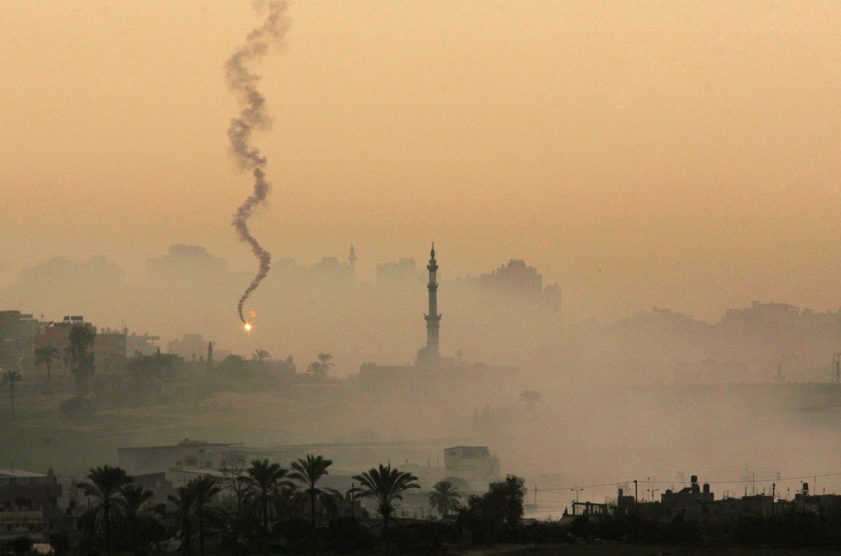 A flare and smoke are seen near a mosque in the Gaza Strip during an Israeli army operation Friday. Associated Press photos (Associated Press photos / The Spokesman-Review)