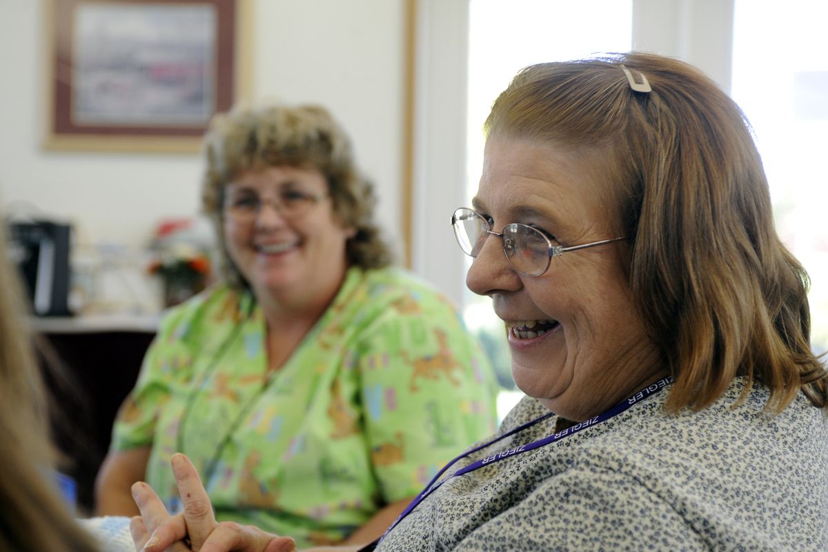 Joanna Morris, right, and Diane Smart, shown at a recent meeting, founded the Twisted Sisters knitting club in Cheney. (Jesse Tinsley / The Spokesman-Review)