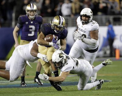 Washington’s Myles Gaskin (9) burned Colorado for 162 yards. (Marcio Jose Sanchez / Associated Press)