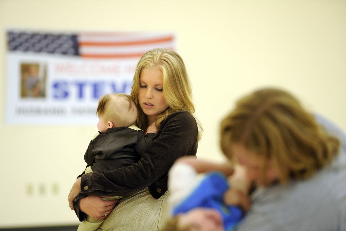 Rebecca Roger holds her son Dylan as they wait for Steven Roger to return to Spokane from a yearlong deployment Friday, Oct. 1, 2010.  (Christopher Anderson / The Spokesman-Review)