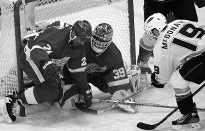 
Anaheim's Andy McDonald pushes the puck past Detroit's Chris Chelios (24) and Dominik Hasek for a goal.  
 (Associated Press / The Spokesman-Review)