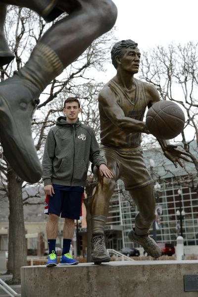 David Stockton stands next to a statue of his dad, John, outside EnergySolutions Arena in Salt Lake City. The statue titled “Threading the Needle” was unveiled in 2005. (Dan Pelle)