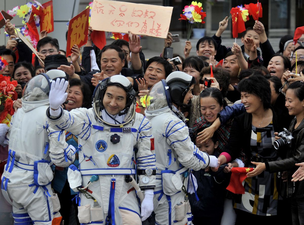 Chinese astronauts Jing Haipeng, Zhai Zhigang and Liu Boming, from left, greet the crowd Thursday during a send-off ceremony  at the Jiuquan Satellite Launch Center. Photos by  (Photos by Associated Press / The Spokesman-Review)