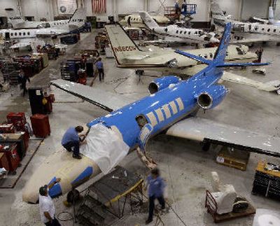 
Workers service Cessna Citation business jets at Cessna's service center in Wichita, Kan. Earlier this year, Cessna Aircraft Co. workers rejected unionizing the plant in Independence, Kan., amid fears the company would build their new Mustang jet elsewhere. 
 (Associated Press / The Spokesman-Review)