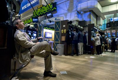 A trader sits at a post on the floor of the New York Stock Exchange on Thursday. Investors sent stock prices higher on optimism that the economy is beginning to rebound. (Associated Press / The Spokesman-Review)