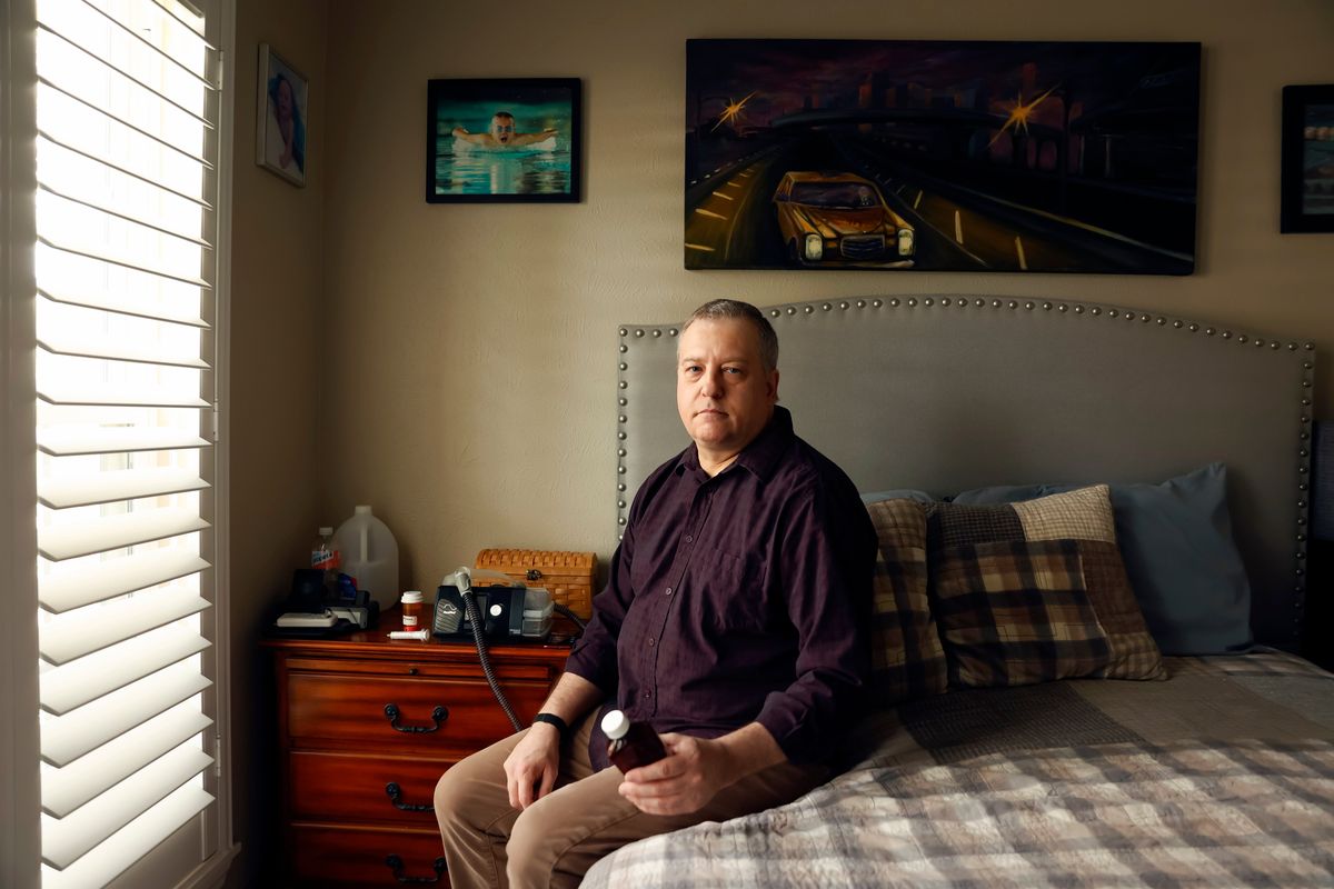 Brian Mahn sits in his home in Cypress, Texas, last week. Mahn says he had to stop taking the drug Xyrem because it was too difficult to wake up in the middle of the night for the second dose.   (MICHAEL STRAVATO)