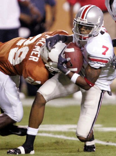 
Ted Ginn Jr., tackled by Texas' Ryan Palmer, caught a 29-yard touchdown pass to help Ohio State prevail.  
 (Associated Press / The Spokesman-Review)