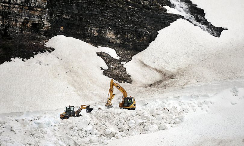Members of the West Side Road Crew work to clear snow from the Big Bend section of Going-To-The- Sun Road on Wednesday in Glacier National Park, Mont.. According Public Affairs Officer Ellen Blickhan the park experienced an above average winter and spring in terms of precipitation. Logan Pass is not expected to be open to visitors until late June or early July. (AP Photo/Daily Inter Lake, Brenda Ahearn)