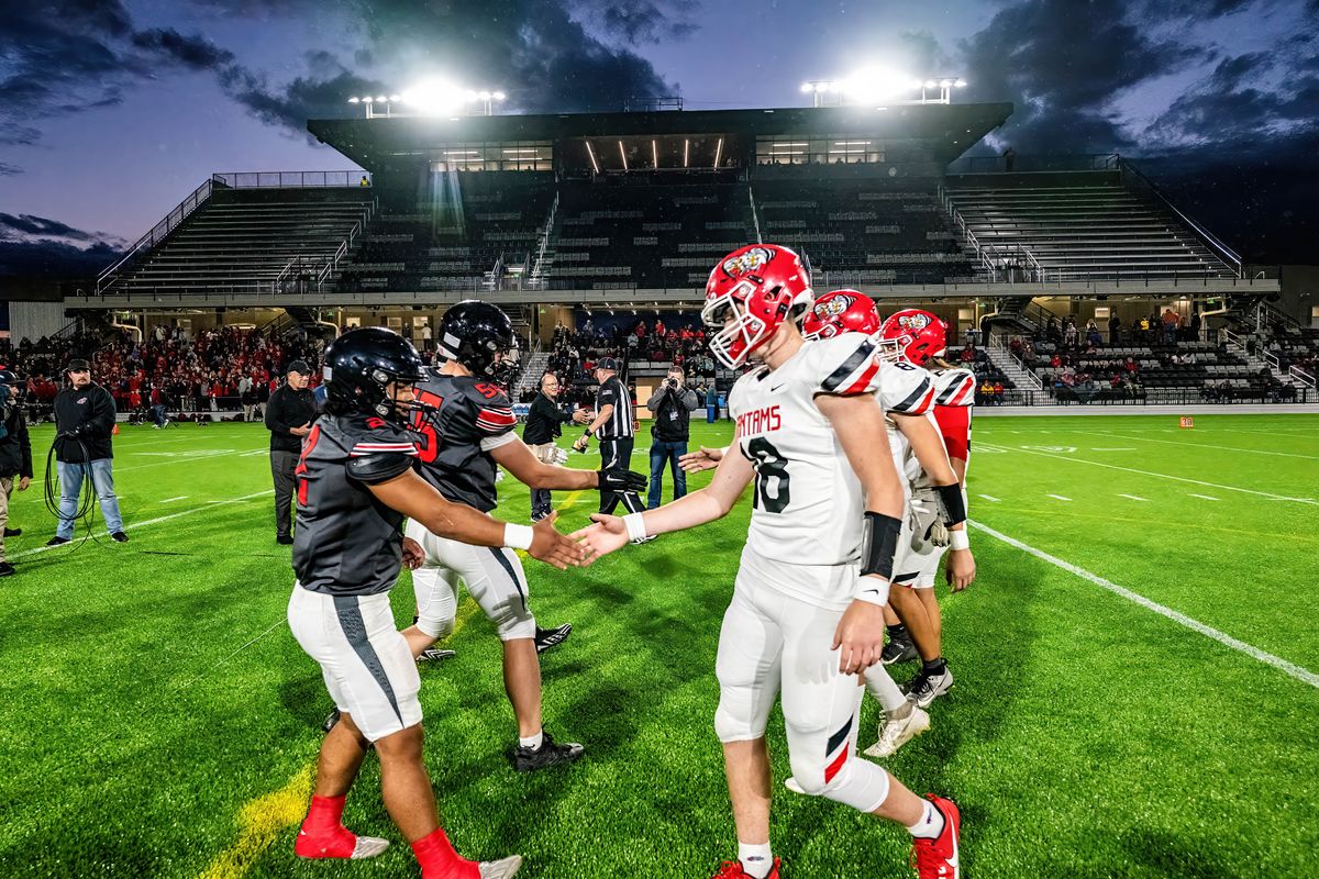 North Central, on right, and Clarkston football players shake hands before the opening night of the new One Spokane Stadium on Sept. 28.  (Colin Mulvany/The Spokesman-Review)